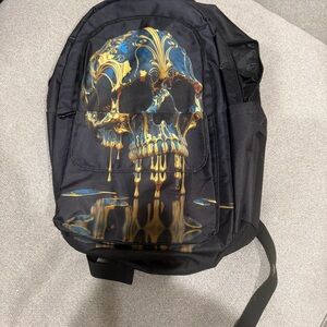 Black Backpack with Gold and Blue Skull Design